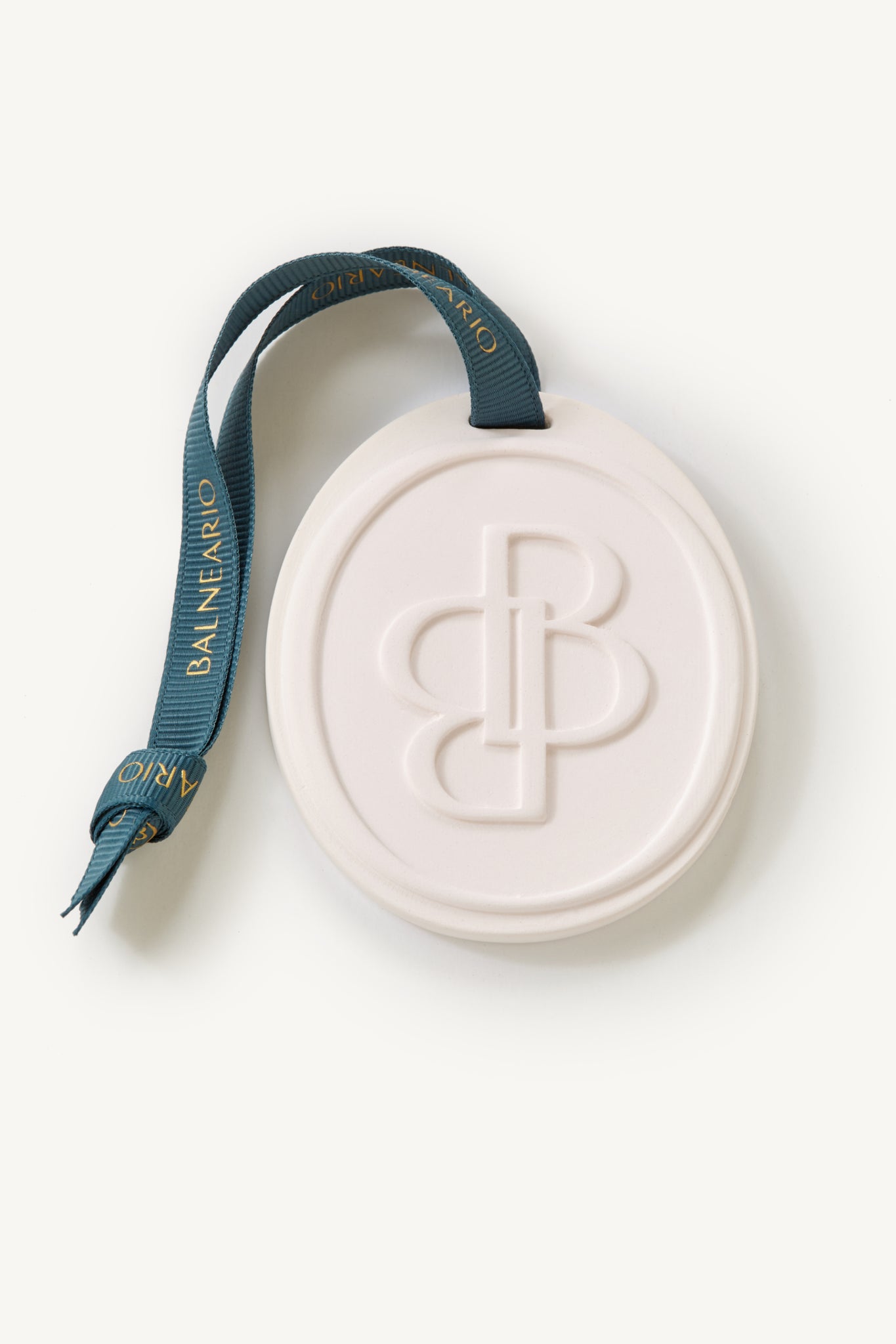 Balneario scented medallion with teal Balneario signature ribbon on a white background