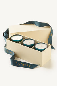 Balneario Luxury Soy-Coconut Votive Candle Trio in teal glassware, in a gift box with branded teal ribbon.